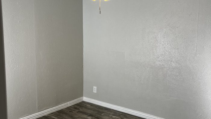 empty room with ceiling fan and hardwood floor at The Calypso Court