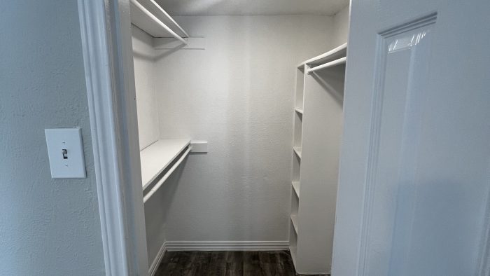 a closet with a white door and wood floors at The Calypso Court